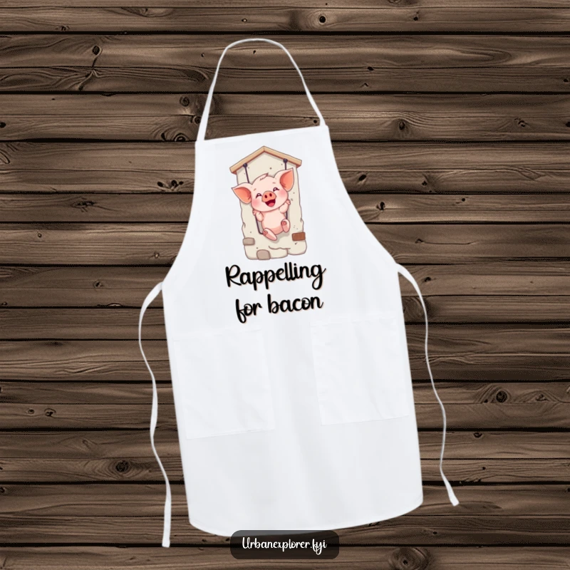 Funny apron featuring a giggling piglet rappelling, perfect for adding humor to cooking and kitchen activities.