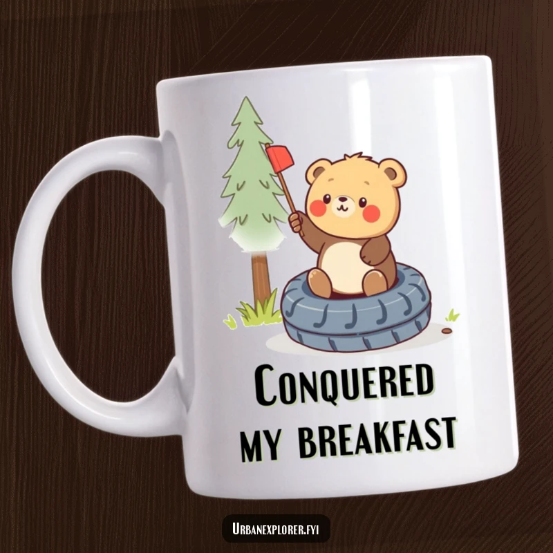 Funny round bear cub triumphantly planting a miniature flag on a discarded tire, depicted on a cheerful mug.