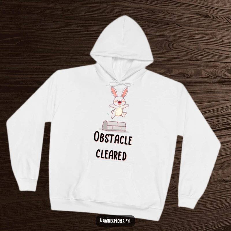 Funny Hoodie featuring a happy bunny character executing a joyful leap over an urban obstacle, designed for ultimate comfort and playful vibes.