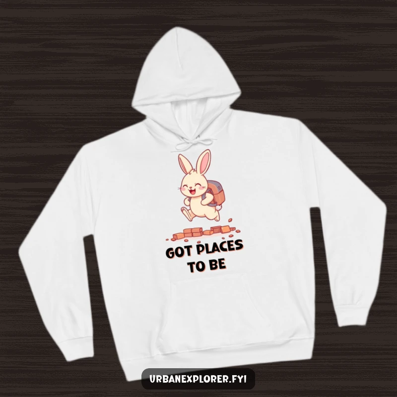 Funny smiling bunny with a backpack, leaping over tiny scattered bricks, a warm and humorous hoodie for achievers.