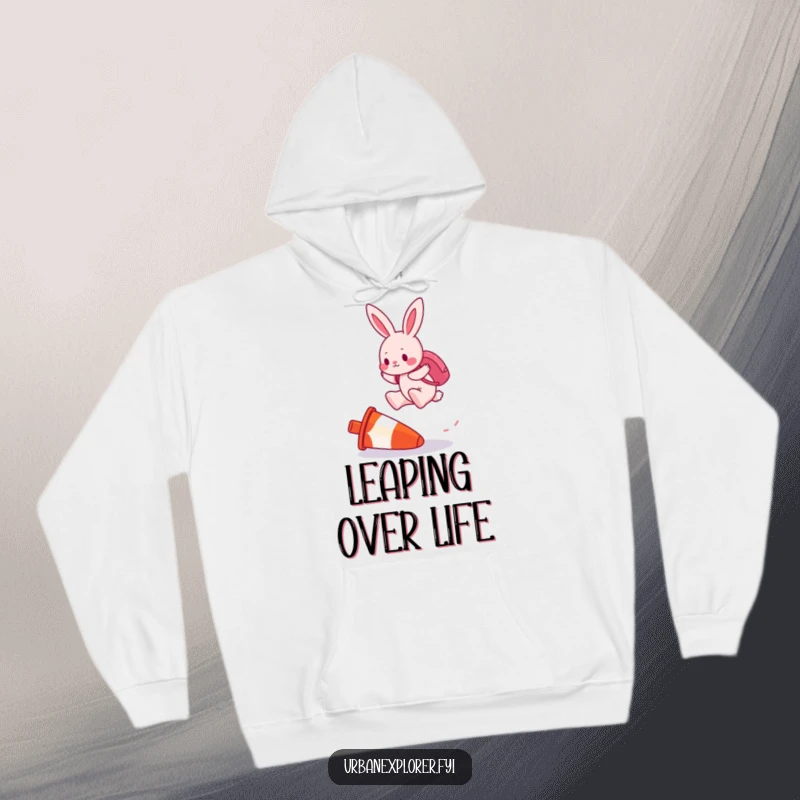 Funny hoodie showing a determined pink bunny with a backpack, mid-air as it jumps over an upside-down traffic cone.