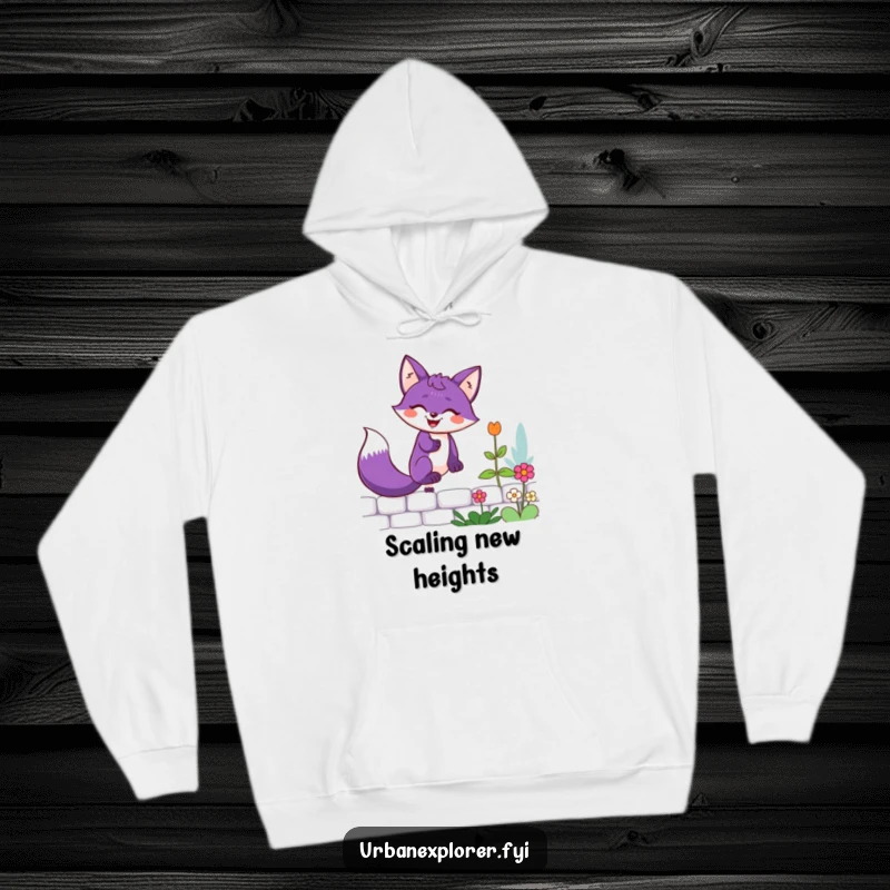 Funny purple fox with a determined grin scaling a garden wall, depicted on a warm and comfortable hoodie.