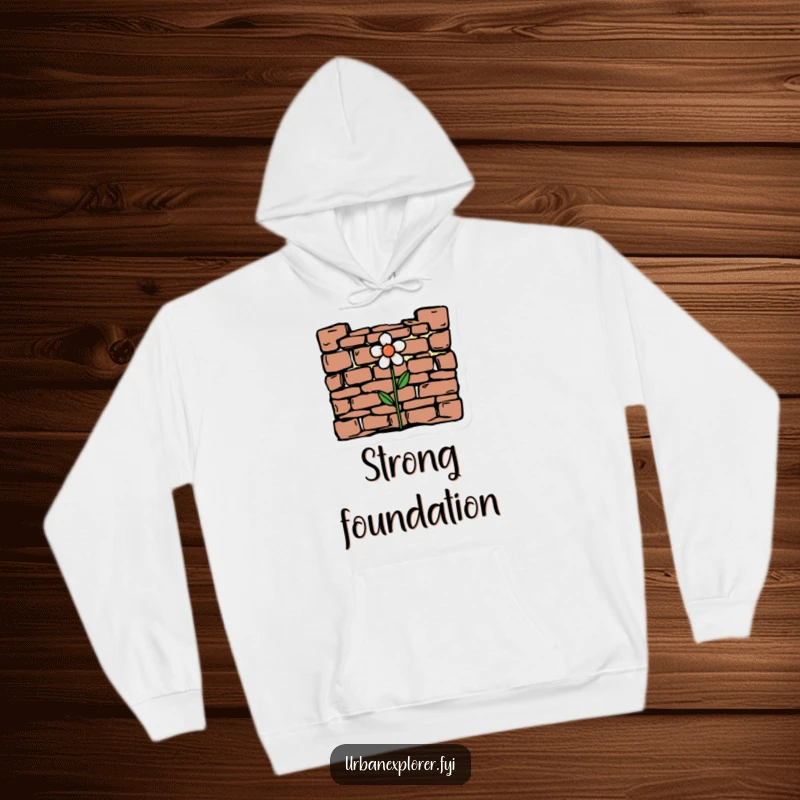 Funny minimalist drawing of crumbling brickwork with a hopeful flower on a cozy hoodie, perfect for embracing resilience.