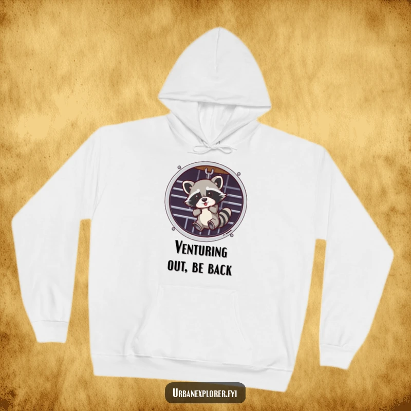 Funny, warm hoodie featuring a raccoon dangling from a ventilation grate, perfect for cozy, humorous wear.