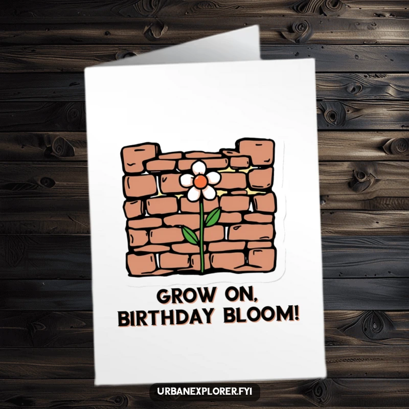 Funny free printable birthday card showing a delicate flower growing through crumbling brickwork, a humorous take on enduring challenges.
